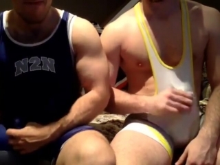 two wrestlers play with their cocks